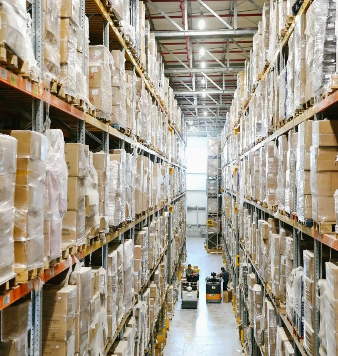 Procurement warehouse aisle stacked with palletised goods